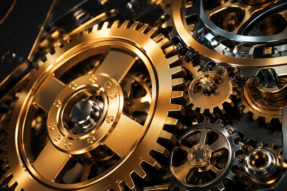 Gold and chrome interlocking gears representing private equity and financial growth.